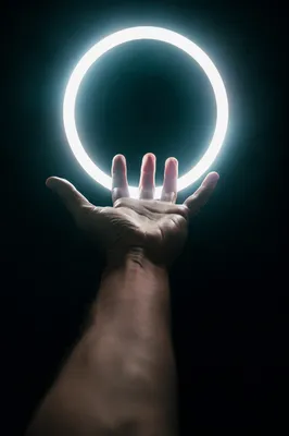 Hand Reaching Toward Halo Light