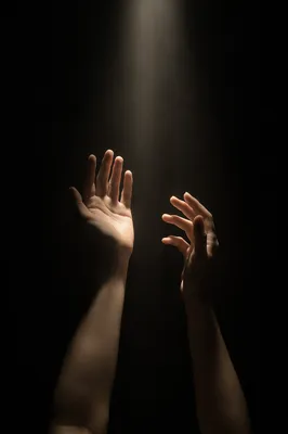 Hands Reaching Toward Hopeful Light