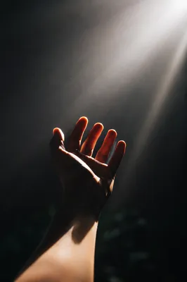 Hand Reaching Toward Divine Light