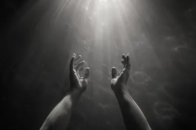 Hands Reaching Toward Radiant Hope