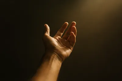 Hand Reaching Toward Warm Hopeful Light