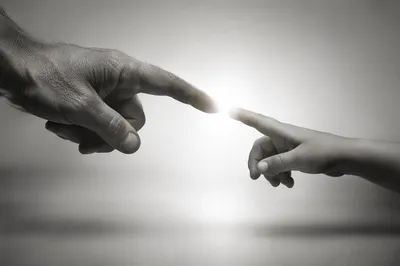 Hands Reaching Toward Hopeful Light