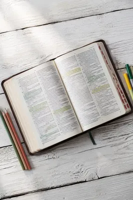 Highlighted Bible Passages on Wooden Table