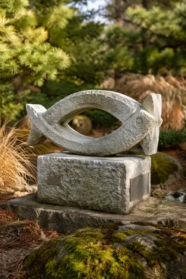 Ichthys Fish Stone Sculpture in Evergreen Garden