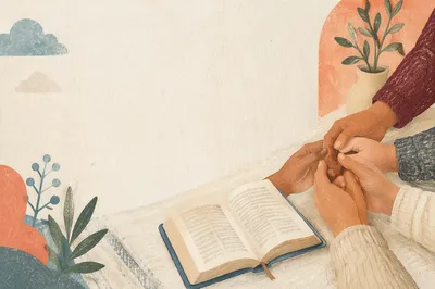Clasped Hands Beside Open Devotional Book