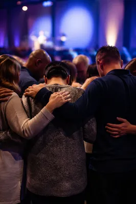 Prayer Circle in Blue Lit Auditorium