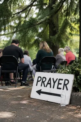 Outdoor Intercessory Prayer Circle Beneath Evergreens