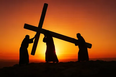 Silhouette of Jesus Carrying Cross at Sunset