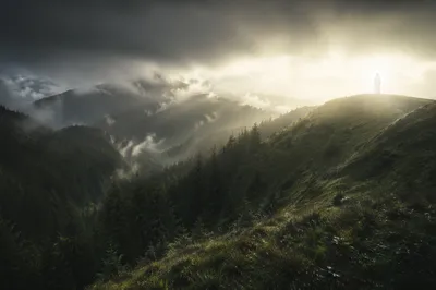 Glowing White Figure on Mountain Ridge
