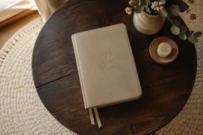 Beige Leather Bible on Dark Wooden Table