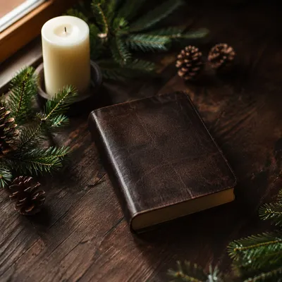 Leather Bible with Evergreen on Walnut Table