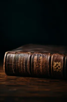 Leather Bible on Dark Wood Table