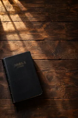 Black Leather Bible on Rustic Wood