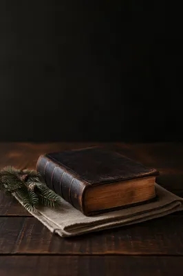 Worn Leather Bible on Dark Walnut Table