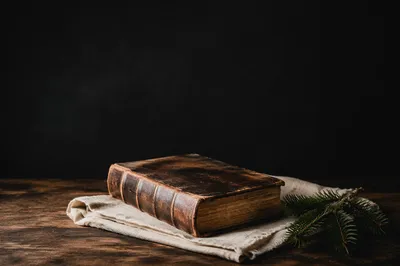 Worn Leather Bible on Dark Walnut Table