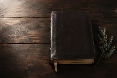 Leather Bible on Dark Wood Table