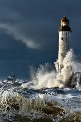 Stormy Lighthouse Beacon Over Crashing Waves