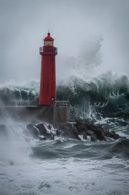 Crimson Lighthouse Beacon Through Coastal Storm