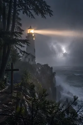 Lighthouse Beacon Through Stormy Evergreen Coast