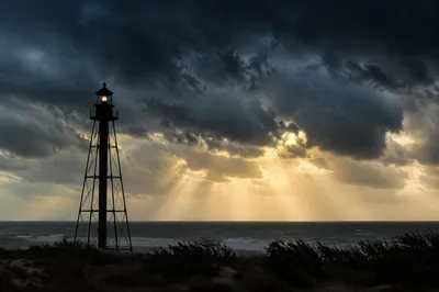 Lighthouse Beacon Through Coastal Storm Clouds