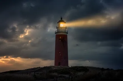 Stormy Lighthouse Beacon at Twilight Coast