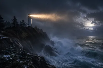 Stormy Lighthouse Beacon Among Evergreen Cliffs