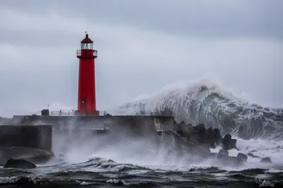 Crimson Lighthouse Beacon in Coastal Storm
