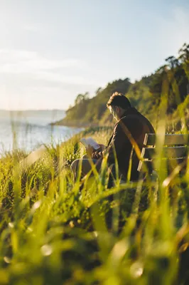 Man Reading Bible in Morning Coastal Light