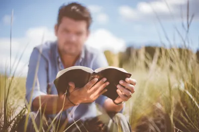 Man Reading Bible in Morning Light