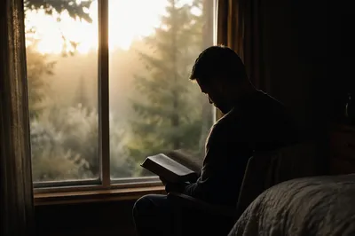 Man Reading Bible in Morning Window Light