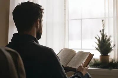 Man Reading Bible in Morning Window Light