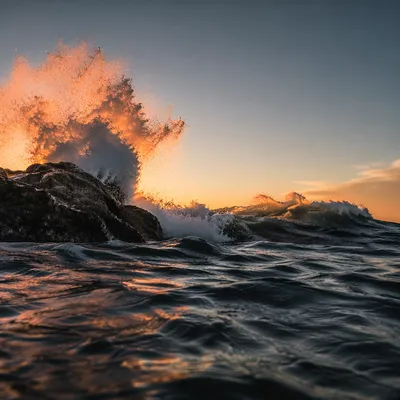 Sunrise Waves Crashing Against Coastal Rocks