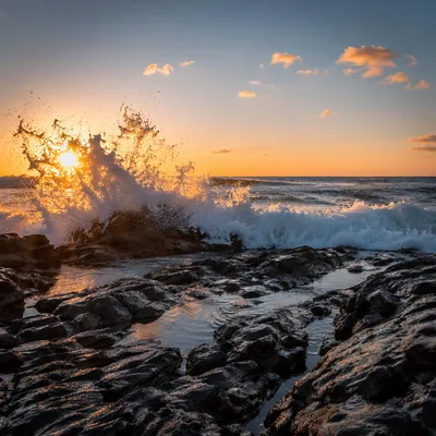 Dramatic Sunrise Waves Crashing on Coastal Rocks