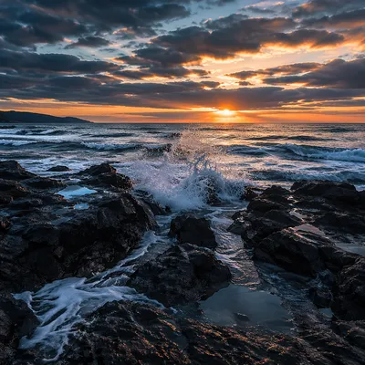 Sunrise Waves Crashing on Rugged Coastal Rocks