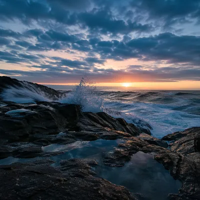 Sunrise Waves Crashing on Rocky Shoreline