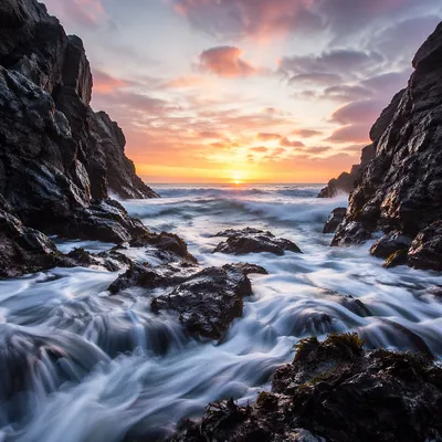 Sunrise Waves Through Rocky Coastal Cove
