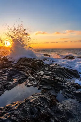Sunrise Waves Crashing on Rugged Coastal Rocks