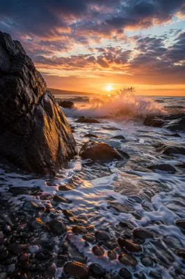 Ocean Waves Crashing on Rocks at Sunrise