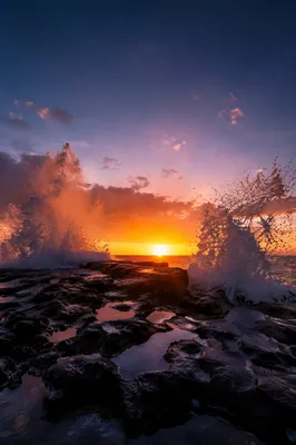 Sunrise Waves Crashing Over Coastal Rocks