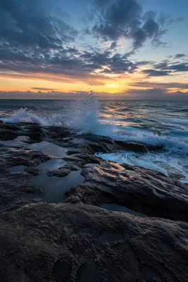 Sunrise Waves Crashing on Rocky Shoreline
