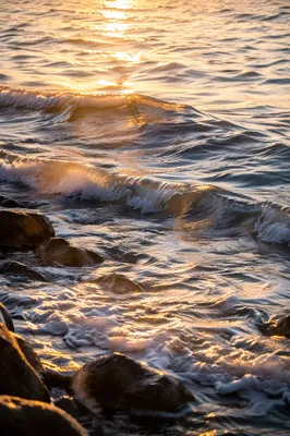 Golden Sunrise Waves Over Rocky Shore
