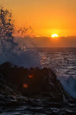 Ocean Waves Crashing on Rocks at Sunrise