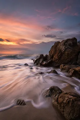 Sunrise Waves Over Steadfast Rocky Shore