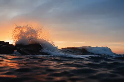 Sunrise Waves Crashing on Coastal Rocks