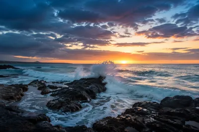 Sunrise Waves Crashing on Rugged Coastal Rocks