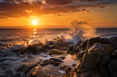 Sunrise Waves Crashing on Rugged Shoreline Rocks