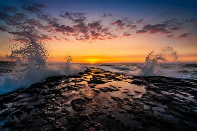 Sunrise Waves Crashing on Coastal Rocks
