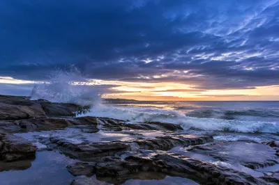 Sunrise Waves Crashing on Rocky Shoreline