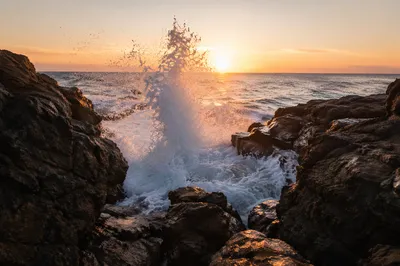 Sunrise Waves Crashing on Rugged Coastal Rocks