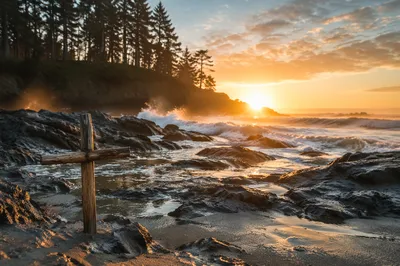 Driftwood Cross by Sunrise Ocean Waves